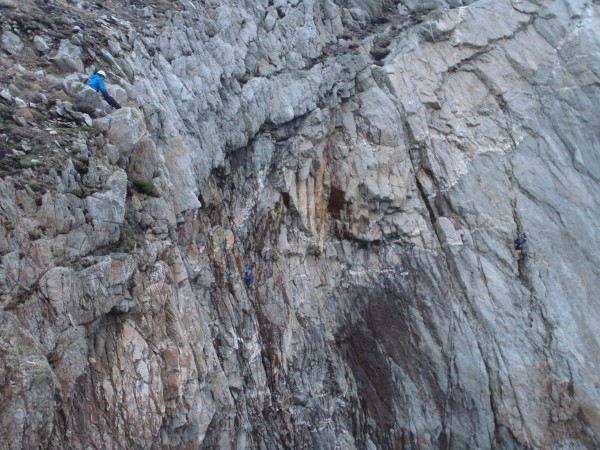 Me belaying Celyn on the final pitch with Liam in the background.