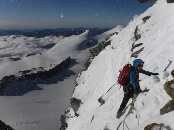 enjoying some easy mixed just below the summit of the allalinhorn, swi...