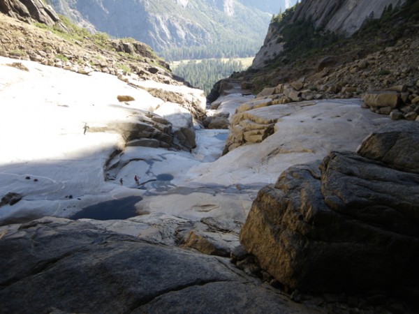 The boys wandering on the water-smoothed slabs.