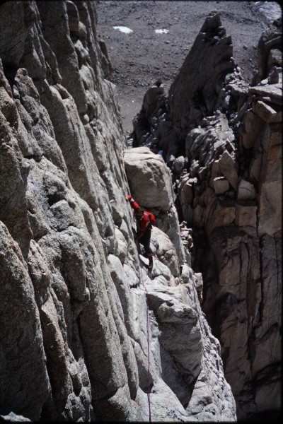 John starting across the ledge.