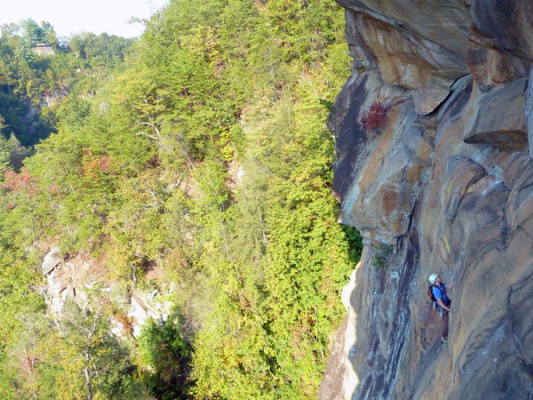 Jimmy heading into the crux on Punk Wave while spectators watch in the...